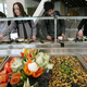 College students line up at dining hall salad bar